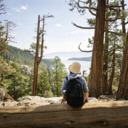 Woman sitting on a log in the woods