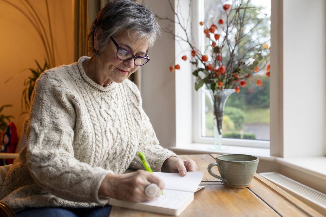 Senior woman writing in her journal.