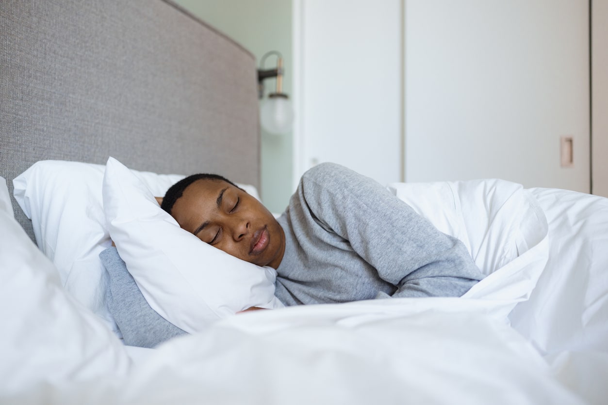 Serene woman sleeping soundly in comfortable bed. 